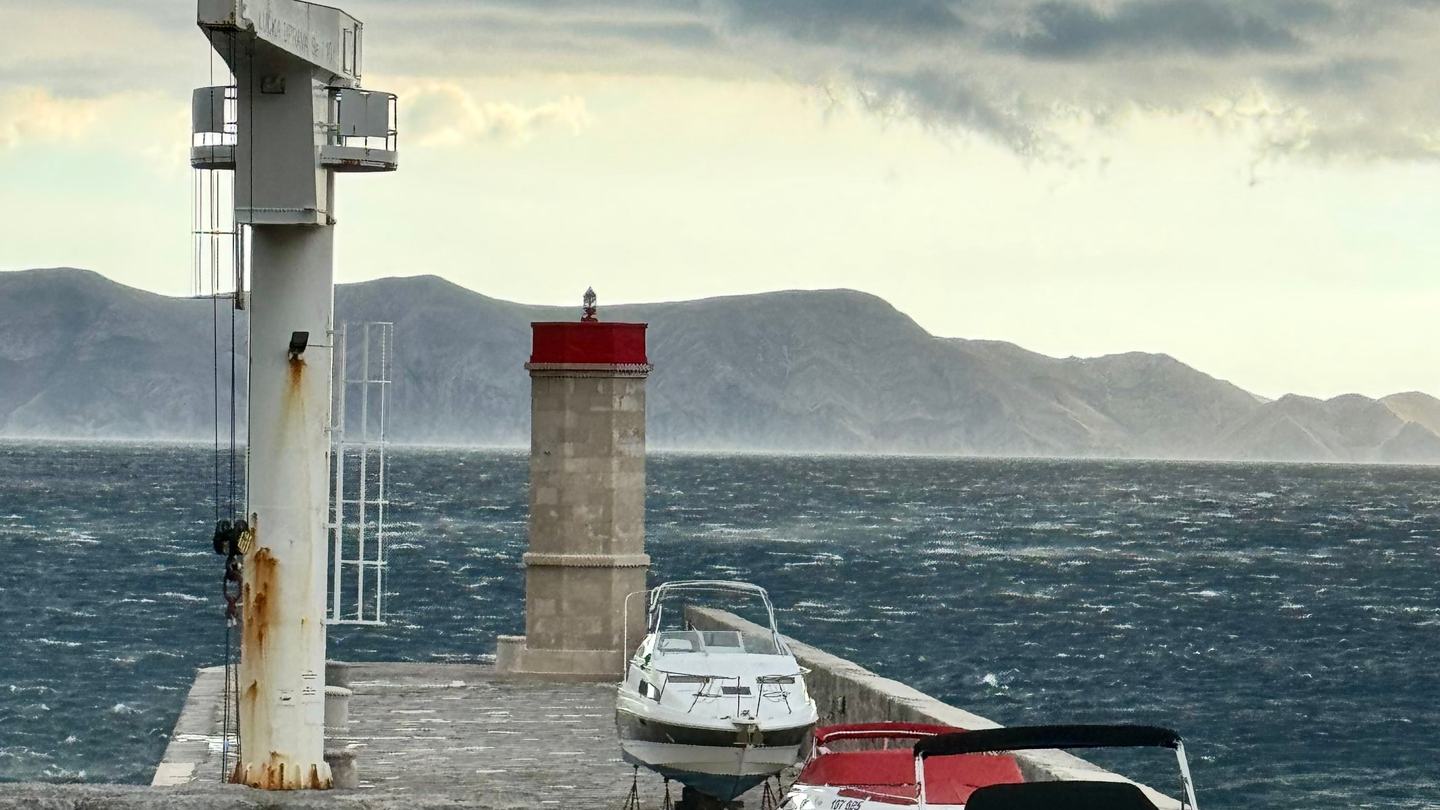 Die Hafenmole von Senj bei Bura, Boote an Land gezogen, gegenüber der Velebit-Kamm